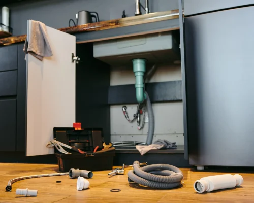plumbing-tools-and-fittings-under-a-kitchen-sink-2026-03-24-11-42-03-utc