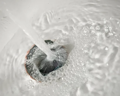 water-flowing-into-a-white-sink-drain-2026-03-15-23-49-42-utc