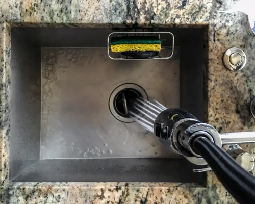 water-spraying-into-a-stainless-steel-kitchen-sink-2026-03-16-06-46-18-utc